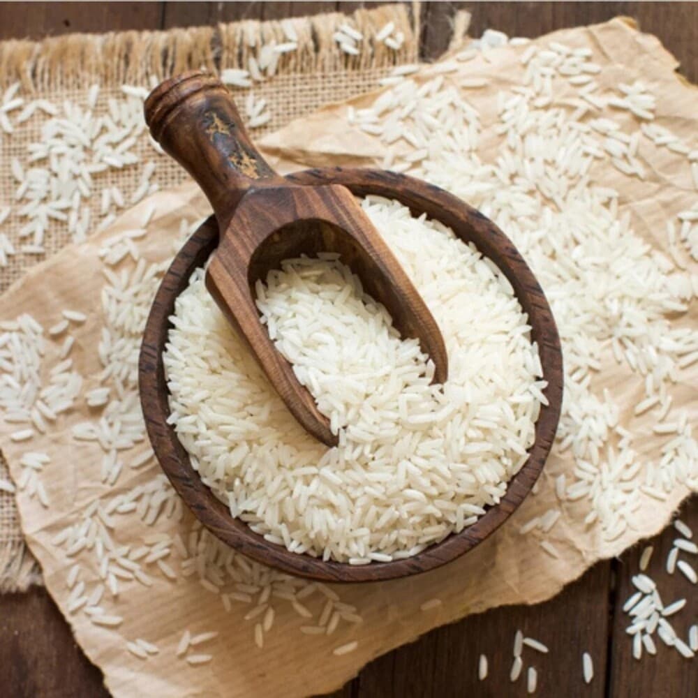 Premium long-grain basmati rice grains in a wooden bowl — rice exporter India